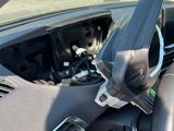 a steering wheel and dashboard of a car with a phone holder on it