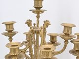 a white and gold chandelier with many candles on it
