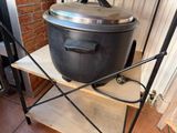 a large pot sitting on top of a wooden shelf