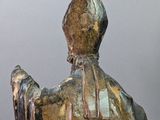 statue of a man with a hat and a robe on a pedestal