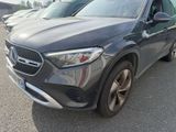 the mercedes suv is parked in a lot with other cars in the background