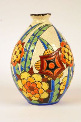 a vase with a flower design on it on a white surface
