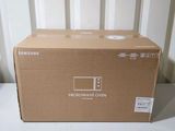 the box of the samsung microwave oven is sitting on the table