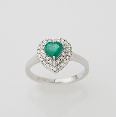 an emerald and diamond heart ring