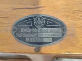 a close up of a wooden table with a metal plate on it