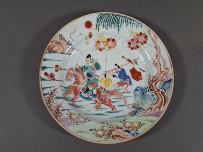 a plate with a picture of a man riding a horse on it