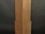 an image of a tall wooden cabinet on a carpeted floor