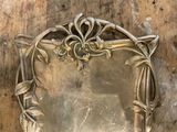 a mirror on the wall that has a design on it