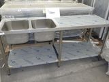 two sinks in the middle of a room with boxes on the floor