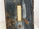 an old metal door with a rusted metal frame and a light switch