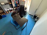 a desk with a computer and a chair in a room