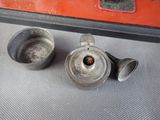 two metal cups sitting next to each other on a table