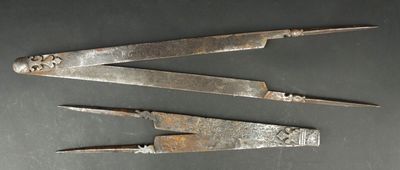 three old metal tools are sitting on a table
