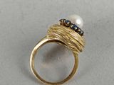 an image of a gold ring with a pearl and blue sapphires