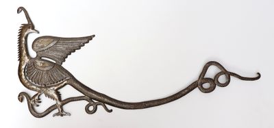 a bird that is sitting on top of a hook