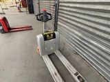 a forklift that is sitting in front of a garage door