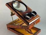 a small wooden box with a magnifying glass in it