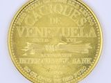 an image of a close up of a gold coin on a white surface