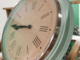 a clock that is sitting on a stand in a room