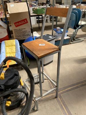 a chair and a table in the middle of a cluttered room