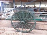 a green wagon that is sitting in a barn