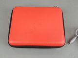 an orange case with a charger attached to it sitting on a table