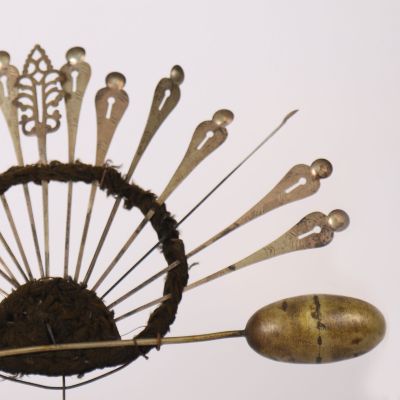 a metal fan that has a bunch of spoons on it