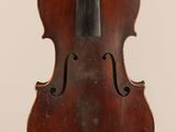 an old violin with a wooden back and bow on a white background