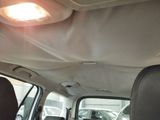 a view of a car ' s sunroofing from the back seat