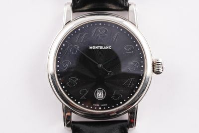 a close up of a wrist watch with a black dial