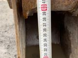 a measuring tape that is on the side of a pipe