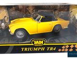yellow triumph tr4 diecast model car in a box