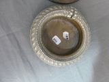a silver plate with a tag on it sitting on a table
