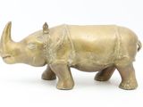 brass statue of a rhinocero on a white background