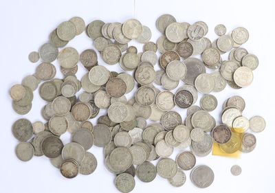 a pile of coins on a white surface with a yellow object
