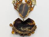 an image of a necklace with a picture of a tiger on it