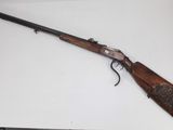 a rifle on a table with a white background