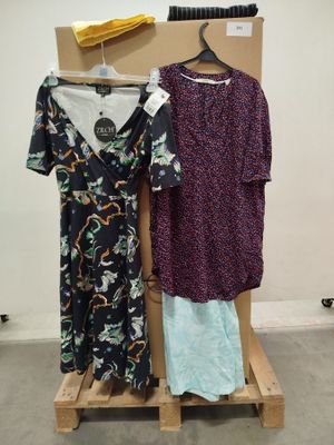 two dresses hanging on a rack in a room