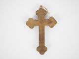 a close up of a wooden cross on a white surface