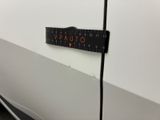 a ruler attached to the side of a white car
