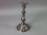 a silver candle holder with a statue on it