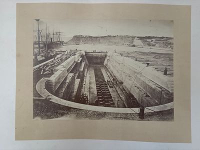 a picture of an old photo of a man standing on a dock
