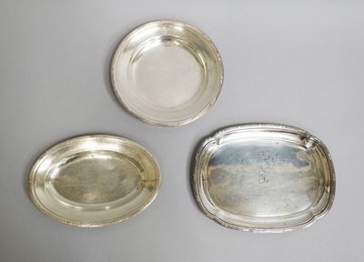 three silver trays on a table with one empty and one empty