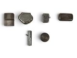 an image of a group of metal objects on a white surface