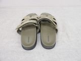 beige leather sandals with two straps on a white surface