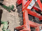 a picture of a tractor with a plow attached to it ' s back