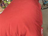 a red pillow sitting on top of a wooden box