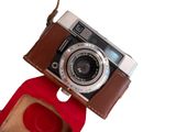 a brown camera with a brown strap on it