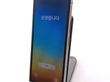 the back of a black phone with a keyboard on top of it
