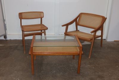 three chairs and a coffee table in a room